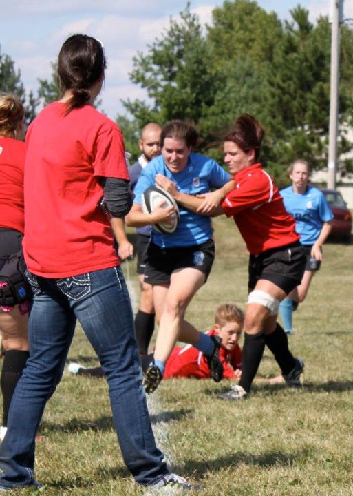 Wisconsin captain and No. 8 Mary Hanks drives the Scylla scrumhalf out of bounds. 
